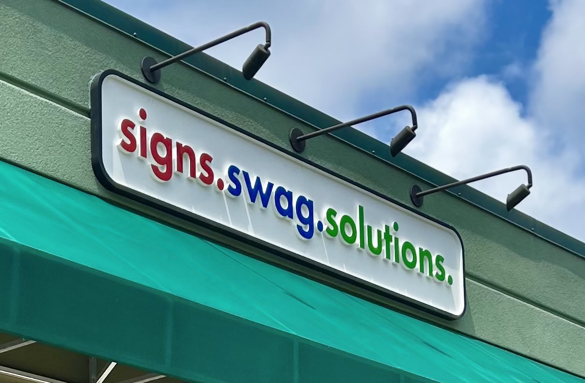 Freshly printed illuminated storefront signage in vivid color